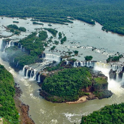 The wide cascades of Iguazu Falls surrounded by rainforest