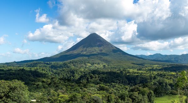The cone of Arenal Volcano above rainforest and hot springs The cone of Arenal Volcano above rainforest and hot springs