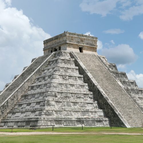 El Castillo pyramid at Chichen Itza under a clear blue sky El Castillo pyramid at Chichen Itza under a clear blue sky